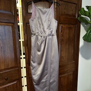 Long, light purple satin bridesmaid dress.